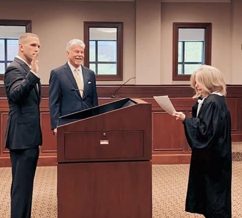Judge Kathleen McCann swearing in Tyler W. McCann to the practice of law.